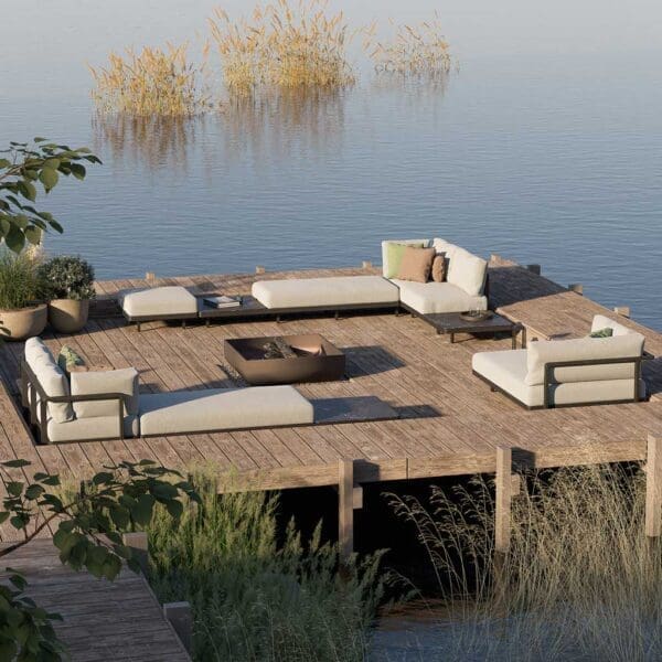 Image of Royal Botania Alura Lounge modern outdoor corner sofas on wooden decking with calm waters of a lake in the background