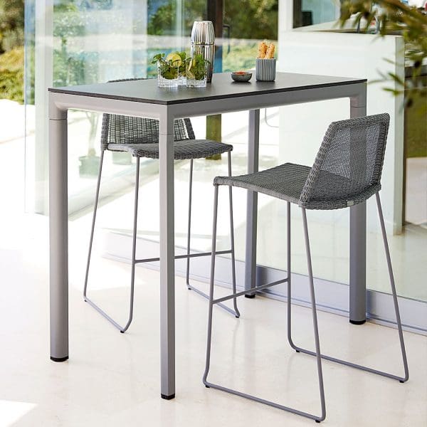 Image of light-grey Breeze bar chairs and Cane-line Drop bar table in light-grey with ceramic table top