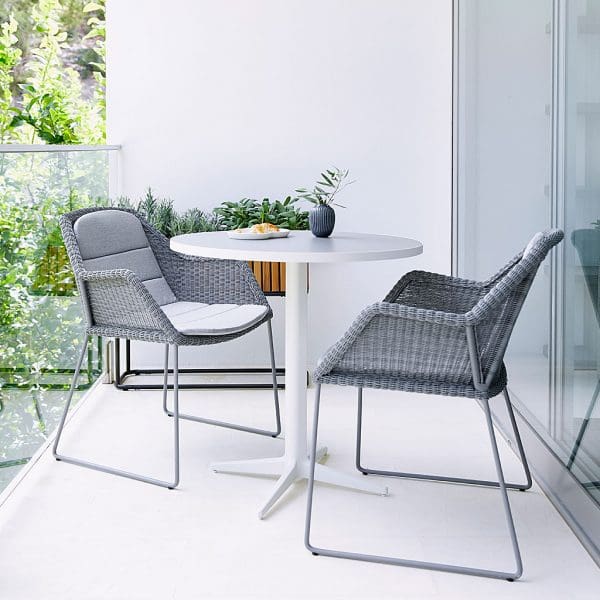 Image of pair of light-grey Breeze rattan carver chairs with white Drop bistro table by Cane-line