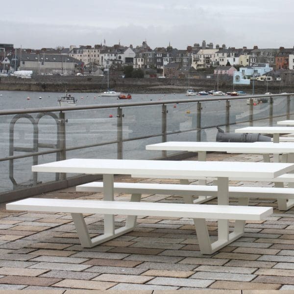 Image of multiple Cassecroute white picnic tables outside Wagamama restuarant in Plymouth historic dockyard