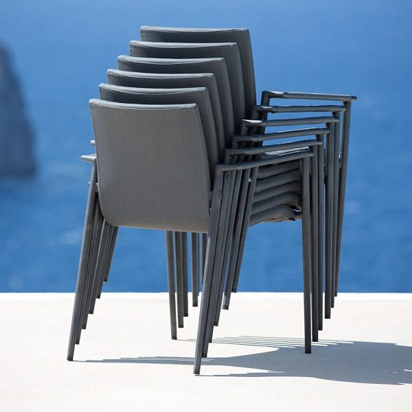 Image of stacked Core upholstered garden armchairs by Cane-line