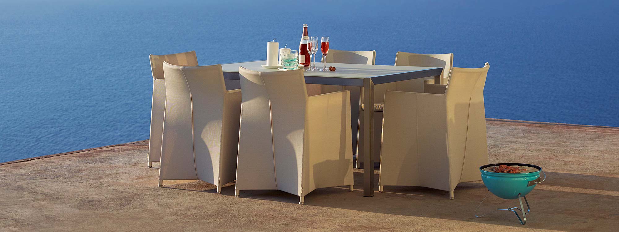 Image of Diamond outdoor dining chairs and Cane-line stainless steel dining table