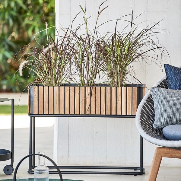 Image of Cane-line Combine raised planter planted with grasses