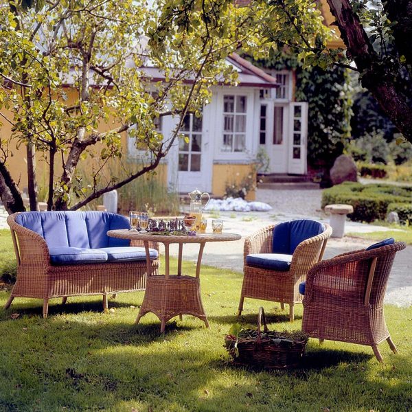Image of Cane-line Derby rattan garden furniture on grass with house in the background