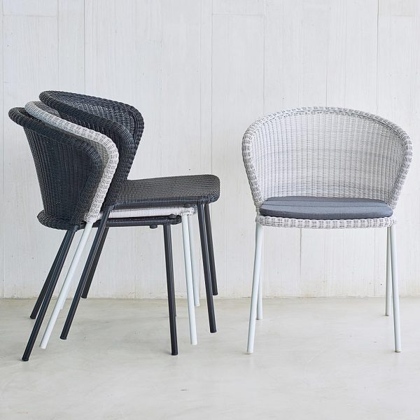 Image of stacked Caneline Lean woven rattan garden chairs in different color finishes