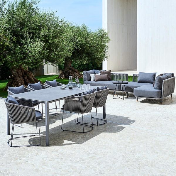 Image of grey Pure outdoor table with Moments grey dining chairs and Moments grey garden corner sofa by Cane-line