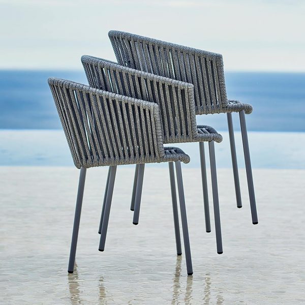 Image of stacked grey Moments garden dining chairs by Cane-line