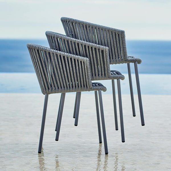 Image of stacked grey Moments garden dining chairs by Cane-line