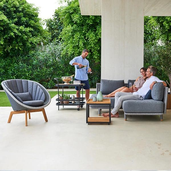 Image of Moments modern garden corner sofa and Peacock outdoor lounge chair by Cane-line