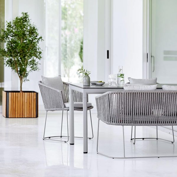 Image of Cane-line Drop dining table and Moments grey dining chairs with Combine teak and lava-grey plant pot in background