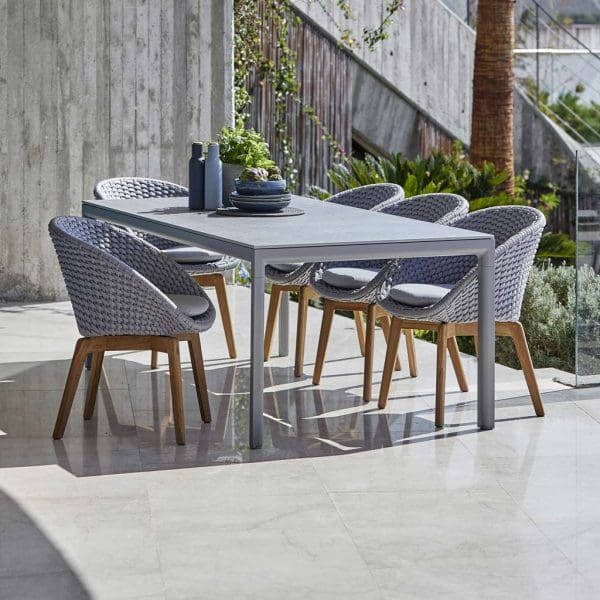Image of light-grey and teak Peacock chairs and light-grey Drop dining table by Cane line garden furniture