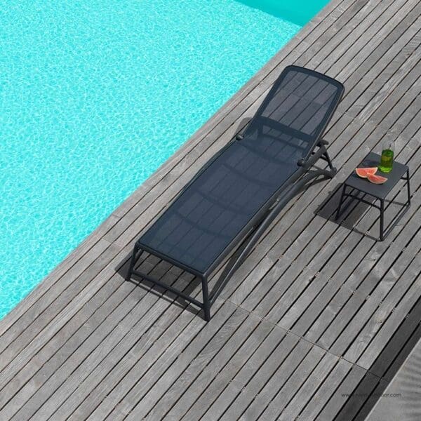 Image of aerial view of Atlantico anthracite coloured hotel sun bed with Pop side table by Nardi, shown on wooden decked poolside