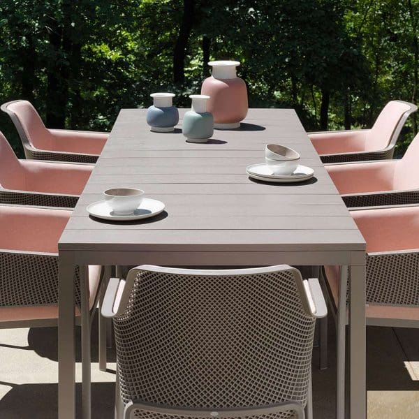 Image looking down the length of Rio taupe garden table with Net taupe armchairs by Nardi either side