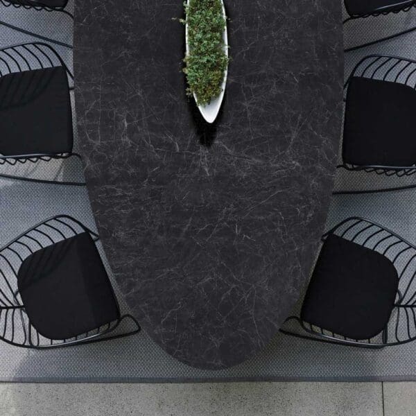 Image of details of Conix oval table top in dark Nero Marquina marble-effect ceramic & Folia black chairs by Royal Botania