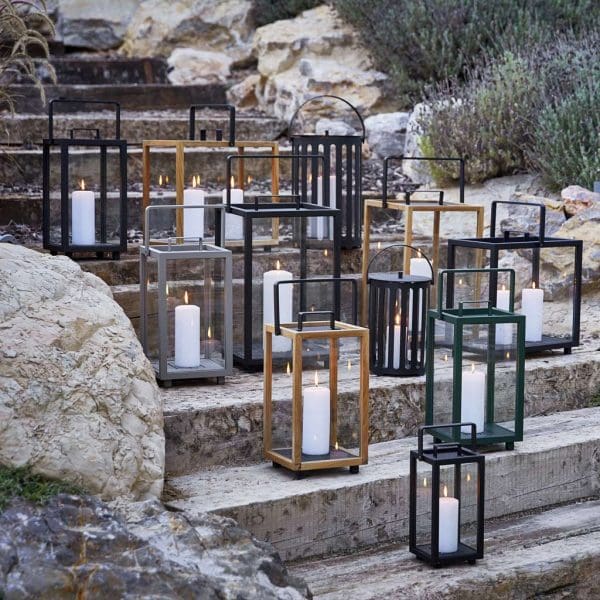 Image of lots of Lighthouse lanterns by Caneline, shown arranged at different heights on outdoor stone steps