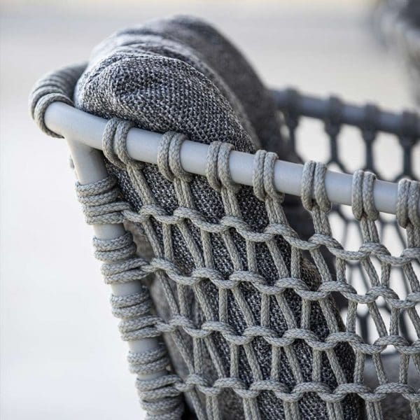Image of detail of taupe colored tubular aluminum frame and taupe Soft Rope weave of Caneline Ocean garden armchair