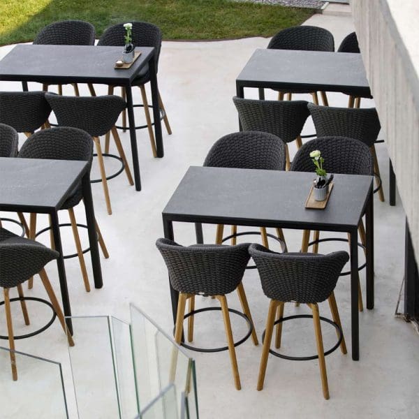 Image of 4 Cane-line Drop bar tables with Peacock bar stools on smart outdoor terrace