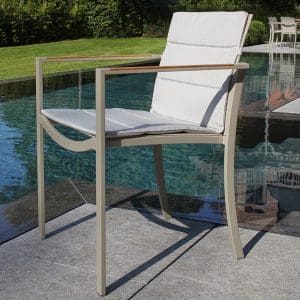Royal Botania OZON carver chair with Sand aluminium frame and Pearl Grey Batyline seat and back on terrace overlooking swimming pool