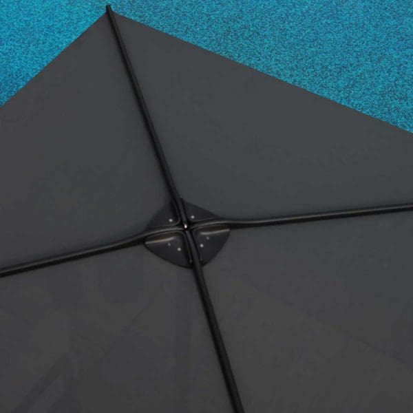 Birdseye view of Royal Botania Oazz parasol with black canopy beside azure waters of swimming pool