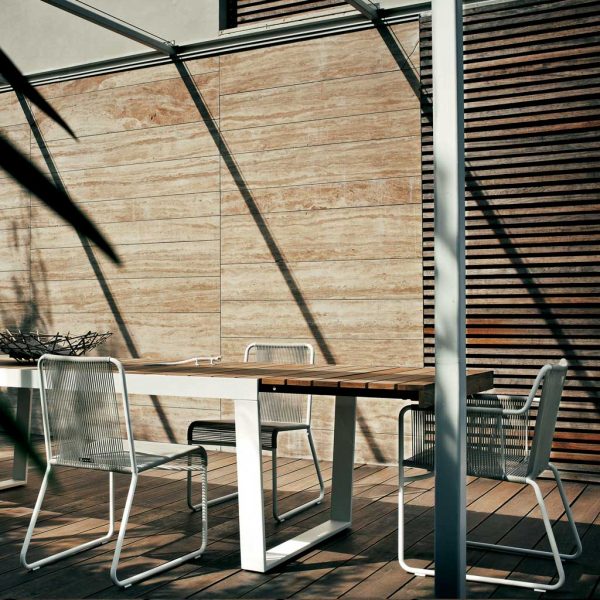 Image of RODA Spinnaker large extending garden table with white base and teak top, shown with Harp white garden chairs