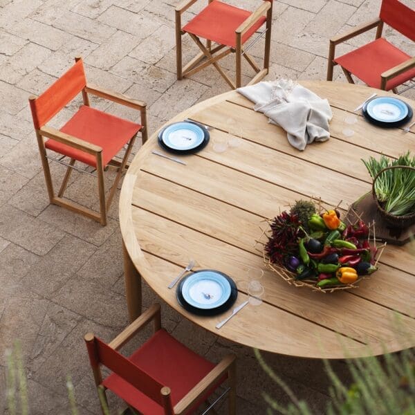 Image of RODA Levante round teak table and Lawrence teak director chairs