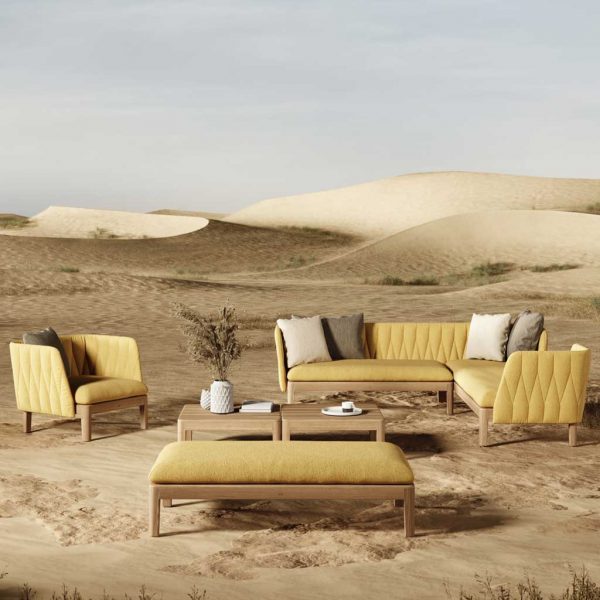 Image of Calypso contemporary teak garden sofa with yellow cushions in expansive sand dunes