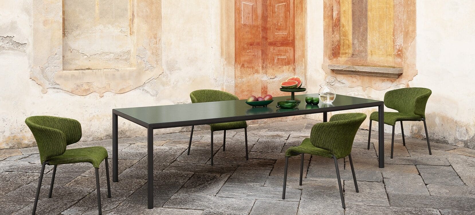 Image of Plein Air garden table with Fern coloured wavy glass top and Double upholstered garden chairs by RODA