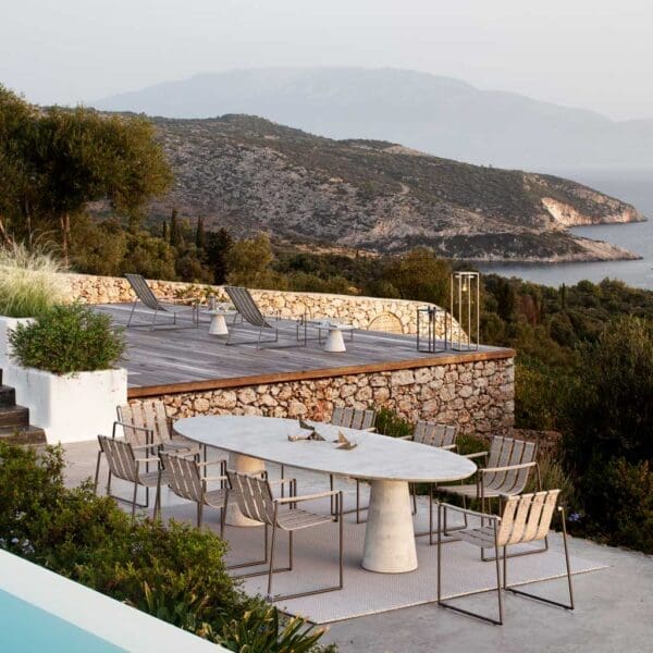 Royal Botania Strappy garden furniture on Mediterranean terrace at dusk.