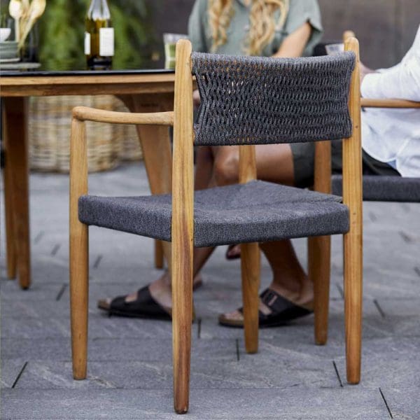 Image from rear of Royal Teak garden armchair with Aspect circular teak table by Caneline in background