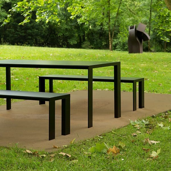 Image of Stua Deneb black modern garden table and benches surrounded by lawn and trees