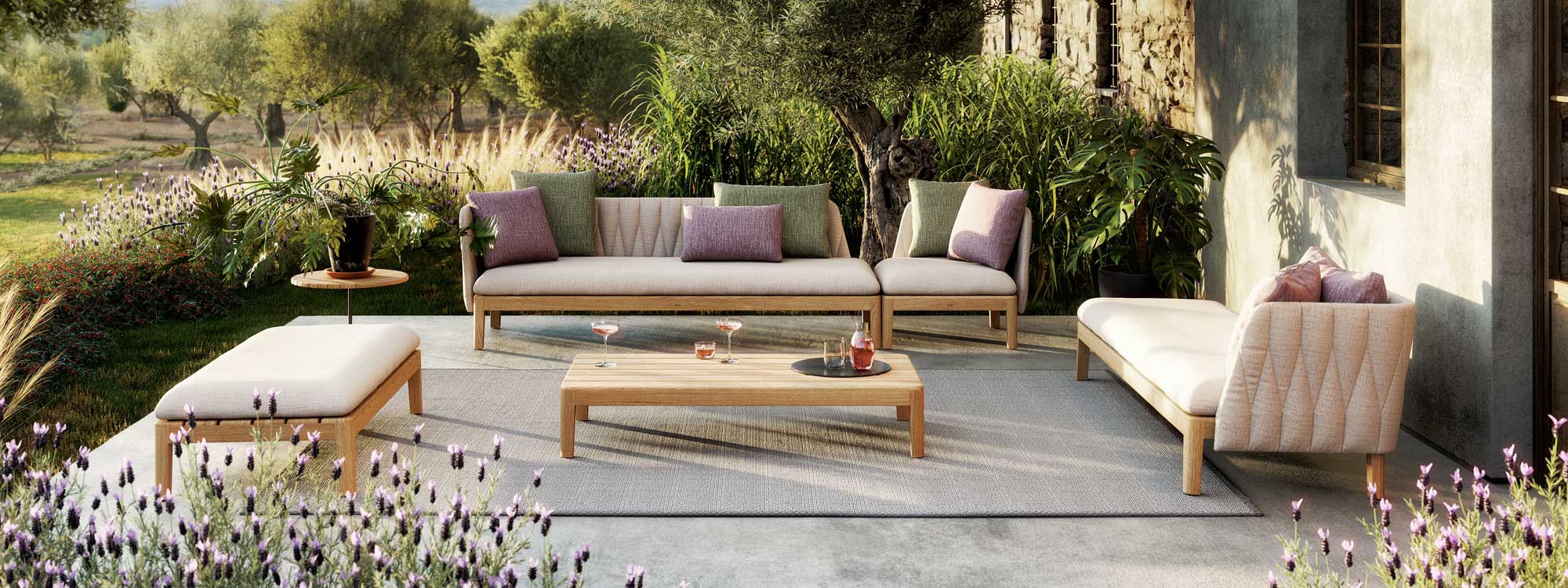 Image of Royal Botania Calypso garden lounge set on terrace surrounded by lush planting