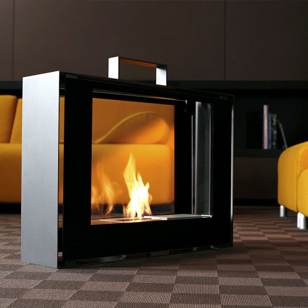 Image of Conmoto Travelmate modern portable fire shown on chequered carpet