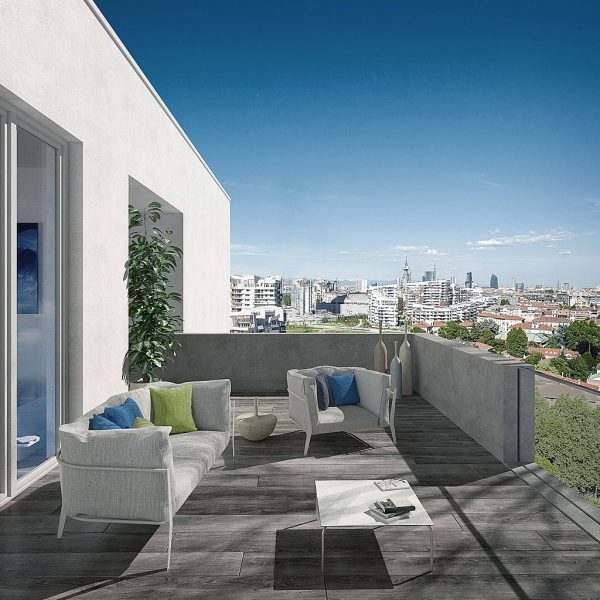 Image of Coro Clea compact garden sofa and lounge chair with white frames and light-grey cushions, shown on rooftop terrace with hazy city skyline in the background