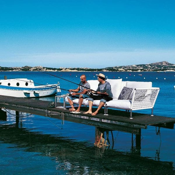 Image of two Italian gents sat on Nest garden sofa, fishing from wooden pontoon.