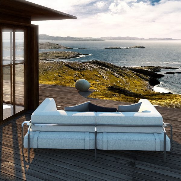 Image of Coro Sabal modern 2 seat garden sofa, shown on decked terrace looking out over coastline, sea and clouds