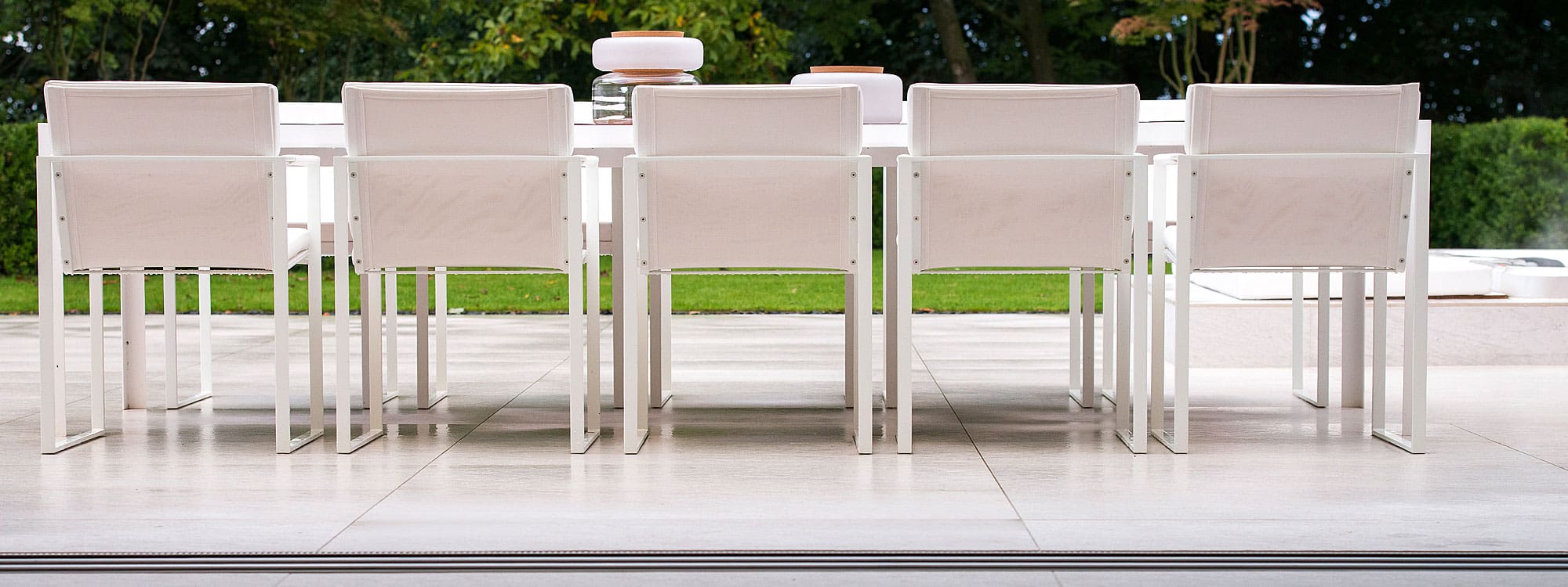 Image of Nimio 12 seat garden table and Butaque white garden chairs by FueraDentro
