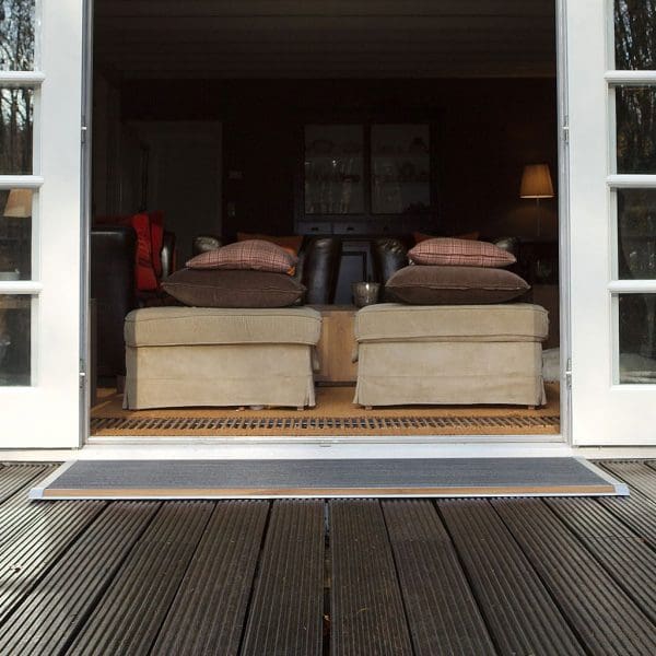 Image of open doorway with RiZZ The New Standard high quality doormat on the threshold outside
