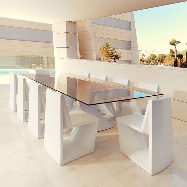 Image of Rest large white garden dining set by Vondom on terrace beneath whitewashed ceiling