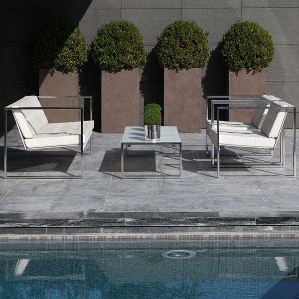 Image of FueraDentro Cima Lounge minimalist outdoor lounge furniture on sunny poolside