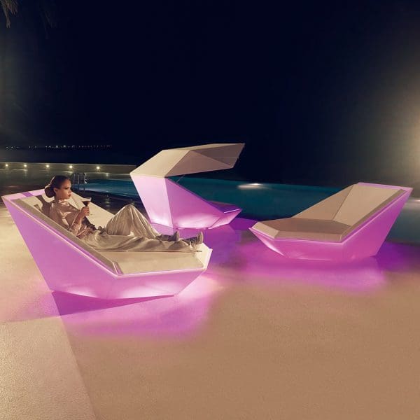Nighttime image of Vondom Faz daybeds with integrated LED lighting