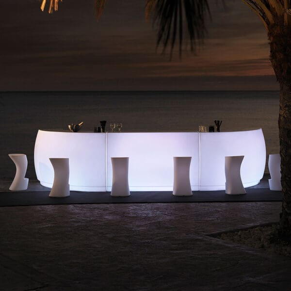 Nighttime image of Fiesta LED illuminated bar counters by Vondom