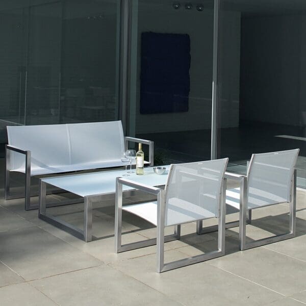 Image of white Royal Botania Ninix small garden sofa, lounge chairs, with bottle of wine and glasses on low table