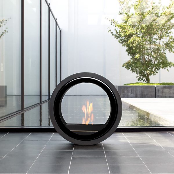 Zen image of Conmoto Roll circular ethanol fire with still water feature and olive tree in the background