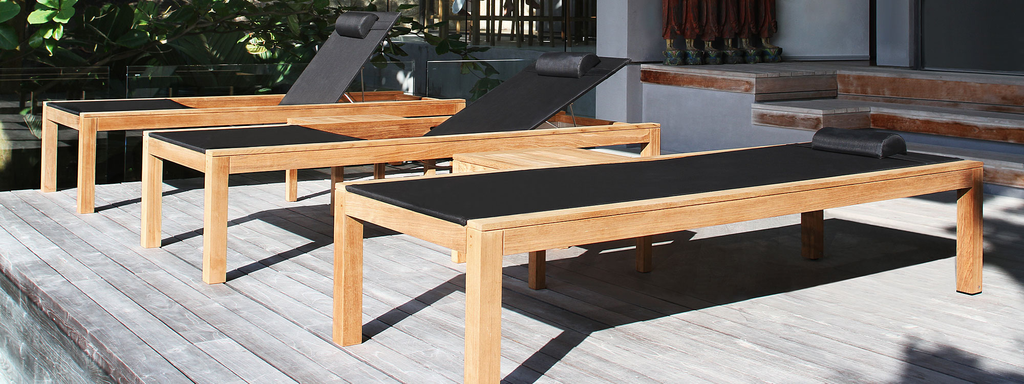 Image of row of three XQI sun loungers on decking by Royal Botania