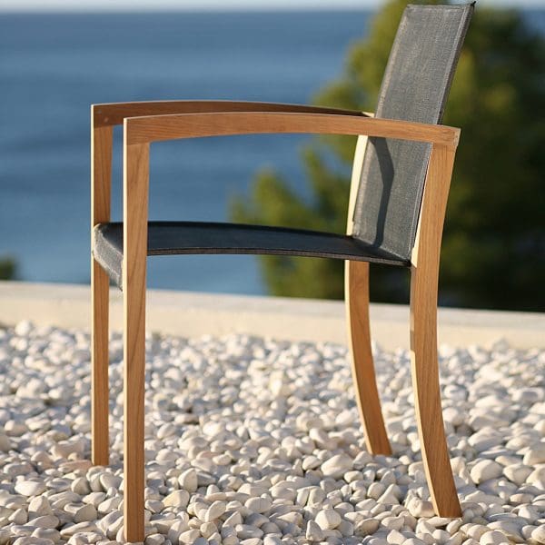 Image of XQI teak carver chair with black Batyline seat and back by Royal Botania