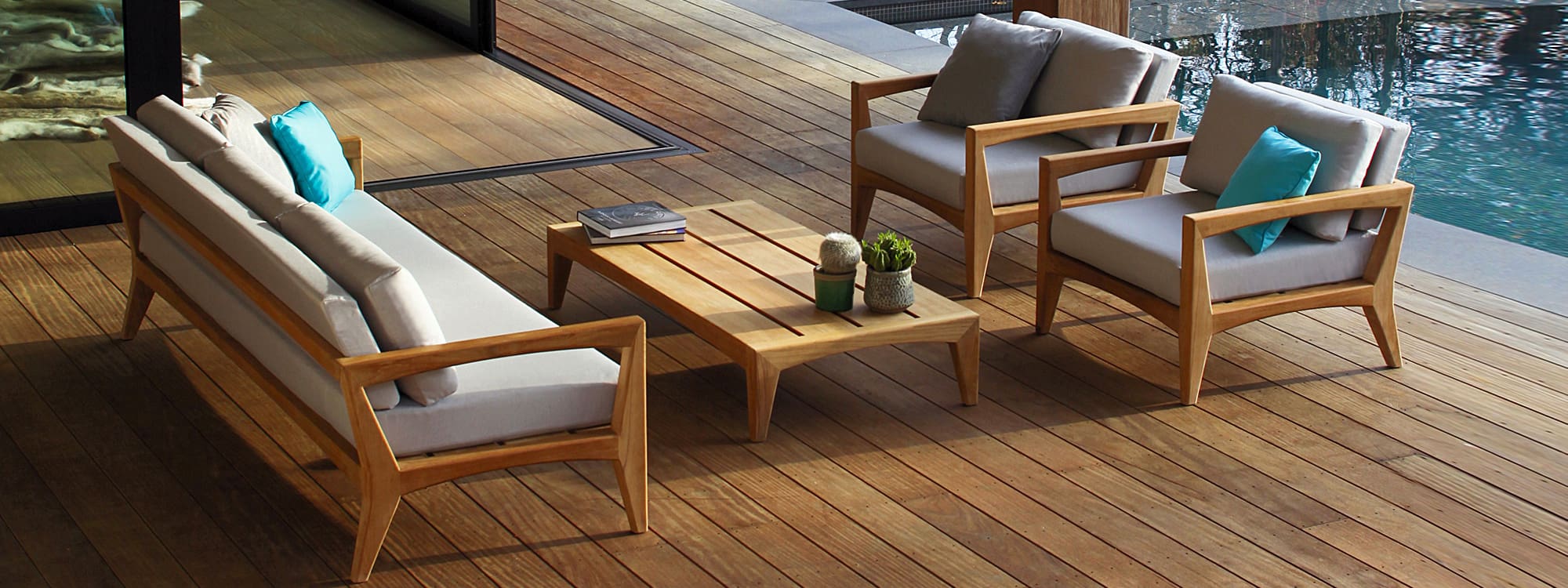 Image of Zenhit Teak Garden Sofa set with light grey cushions on poolside decking