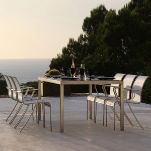 Dusk image of QT55 chair and Taboela table in white and stainless steel by Royal Botania