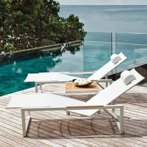Image of pair of white Ninix sun beds with teak arm inserts by Royal Botania
