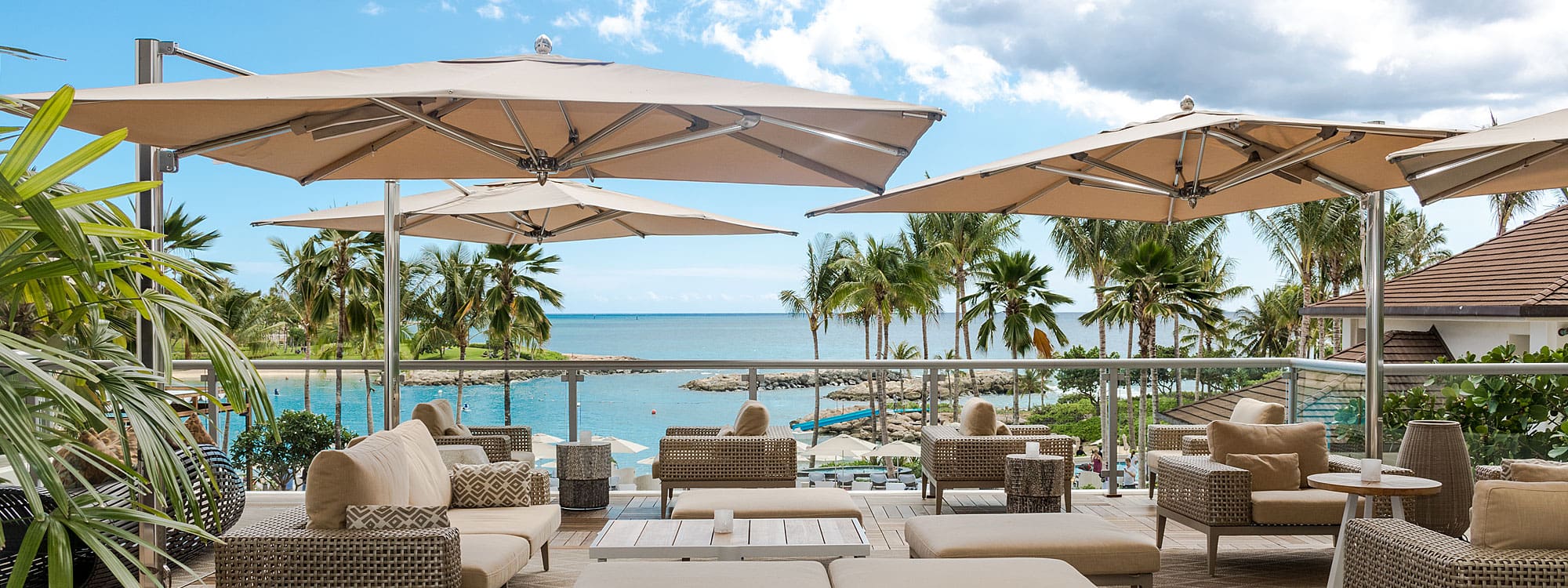Beach Club Shot Of Tuuci Ocean Master Max cantilever parasols & luxury sun shades in marine grade parasol materials are high-spec hospitality and hotel parasols