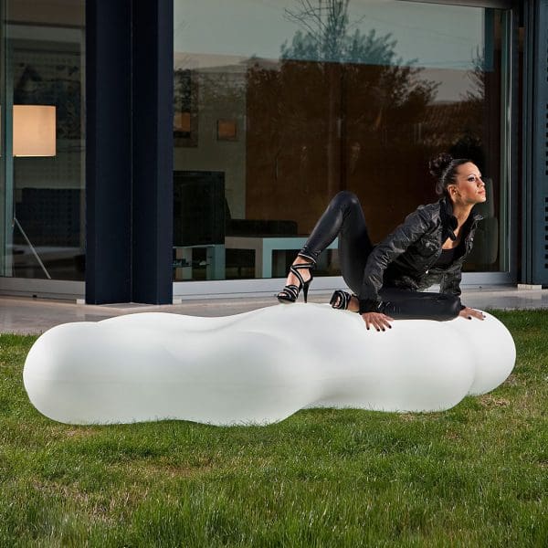 Image of woman dressed in back kneeling on Lava white outdoor sculpture by Vondom